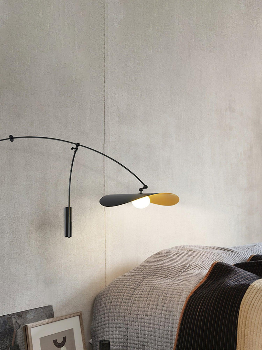 Tall crop of this Clérachic wall light on a concrete-look wall above grey bedding and a framed print.