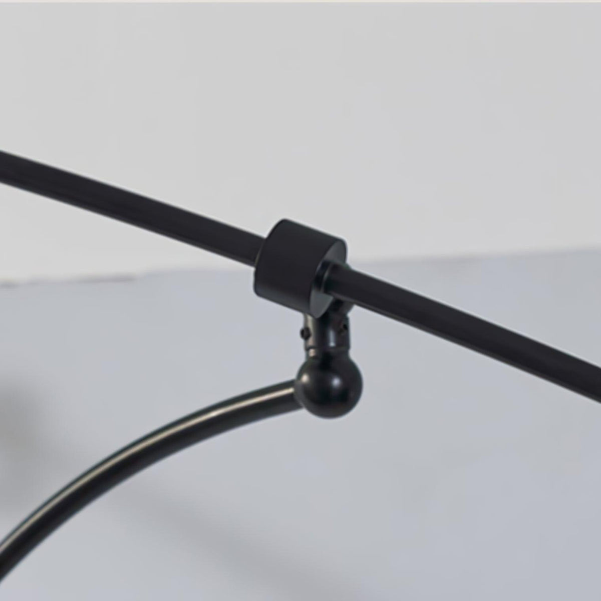 Close view of the swivel joint and collar on the black arm of this Clérachic wall light.