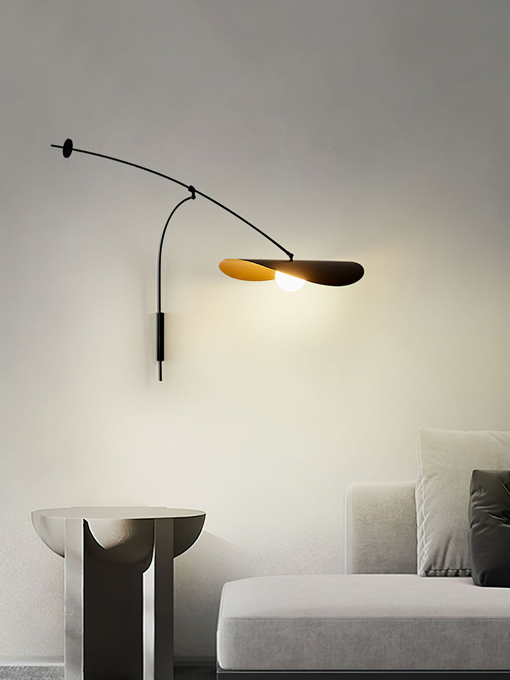 Narrow view of this Clérachic wall light above a sculptural side table and a light sofa, the shade softly lit.