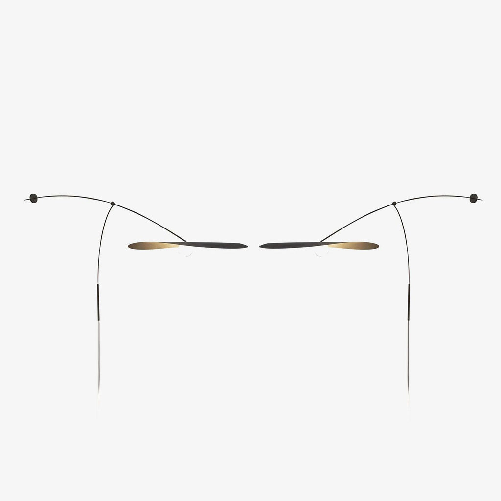 A mirrored pair of Clérachic wall lights on a pale backdrop, shown small with their shades facing each other.