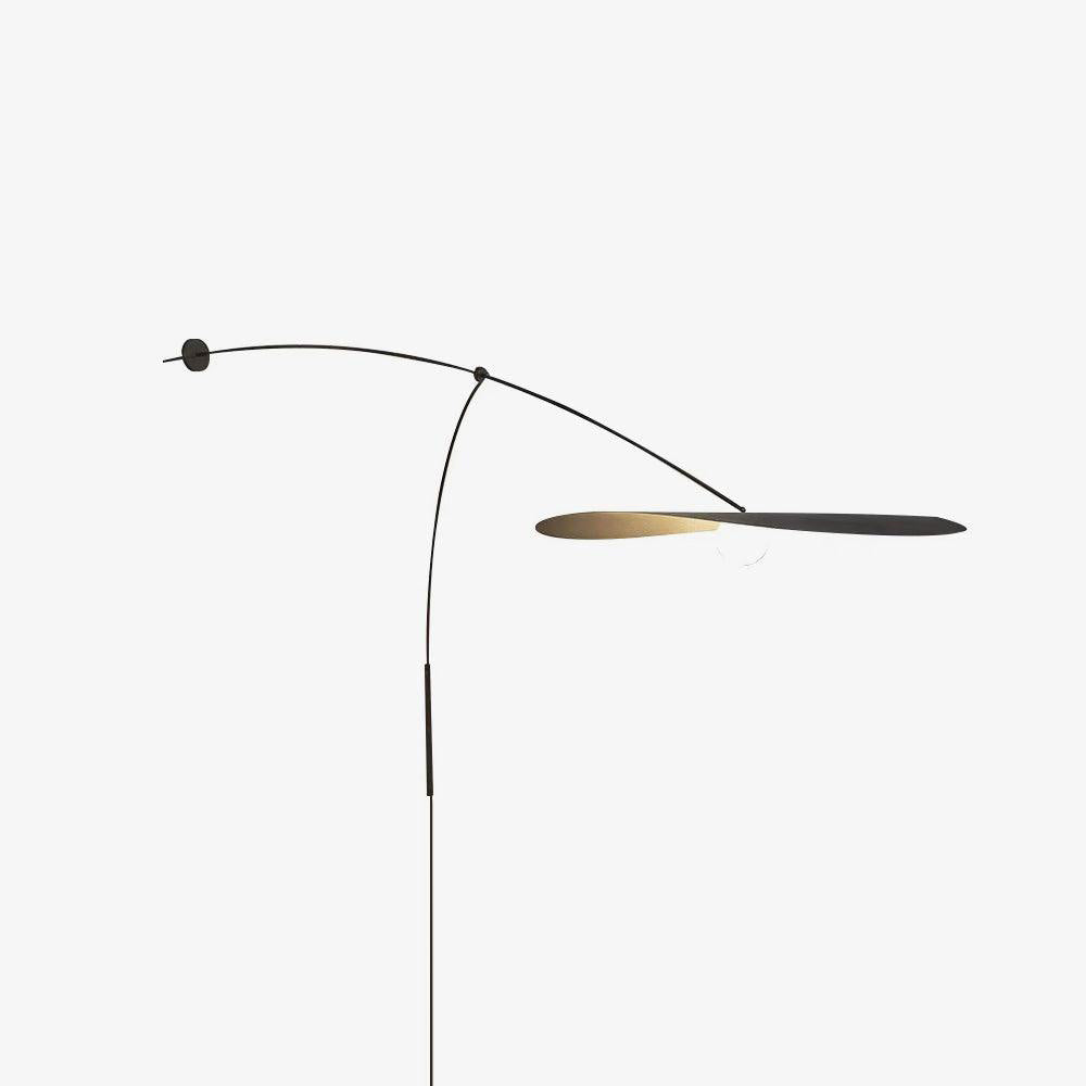 This Clérachic wall light on a pale backdrop, the shade turned edge-on, with a thin black stem and a round wall plate.