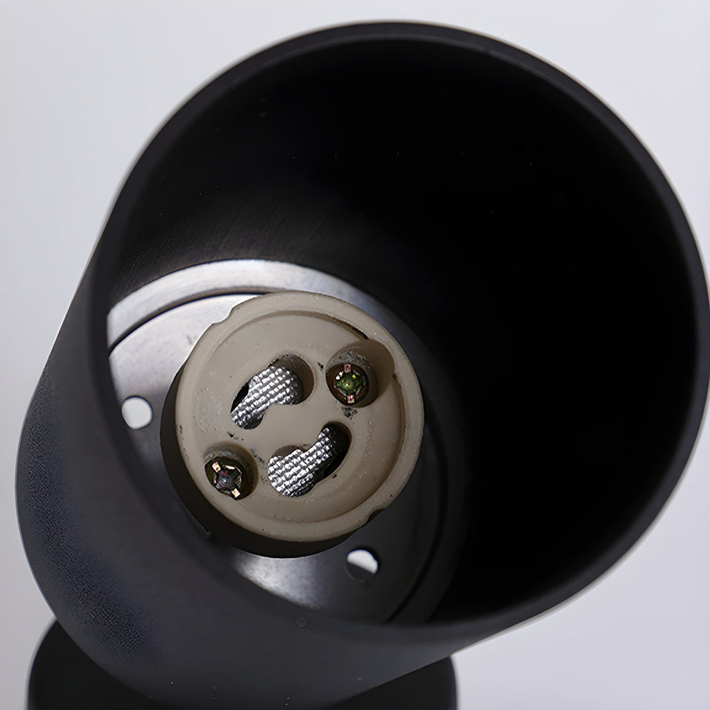 Looking up inside the black cylinder of this Clérachic spotlight, where the lamp holder and its screw terminals sit.