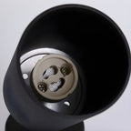 Looking up inside the black cylinder of this Clérachic spotlight, where the lamp holder and its screw terminals sit.