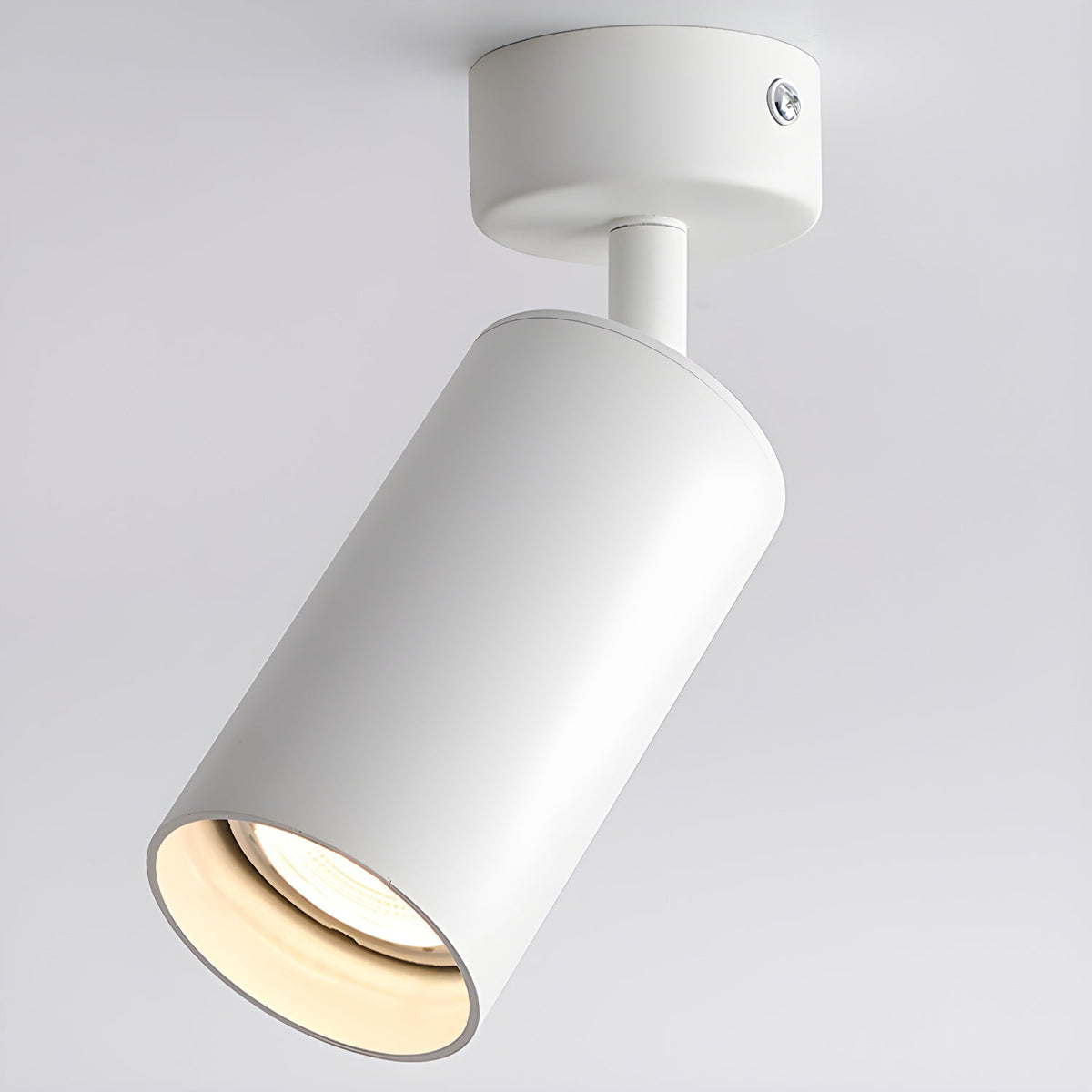 White Clérachic spotlight seen from below and to the side, with the cylinder pointed down and light filling the shade.