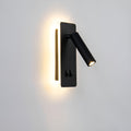 Clérachic reading wall light in black, its rotating spot beside a warm backlit panel.