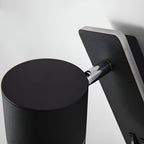 Close-up of the Clérachic reading light's rotating cylinder head and chrome swivel joint.