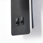Close-up of the Clérachic reading light's two rocker switches on the black backplate.