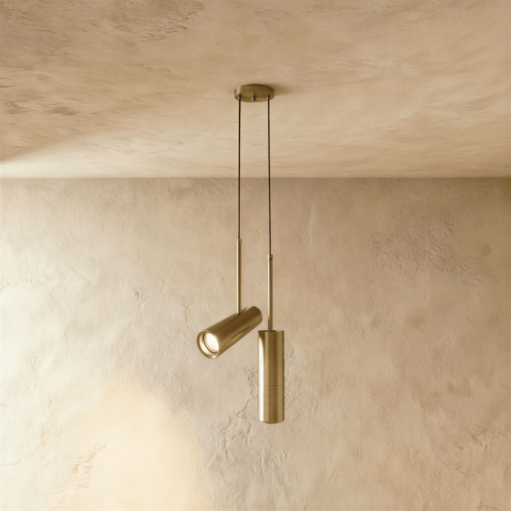 Clérachic pair of brass-toned cylinder pendants from one round ceiling plate, one angled spot head and one straight.