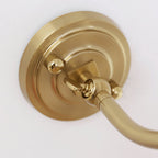 Close view of the round, stepped gold backplate and the arm joint on this Clérachic wall light.