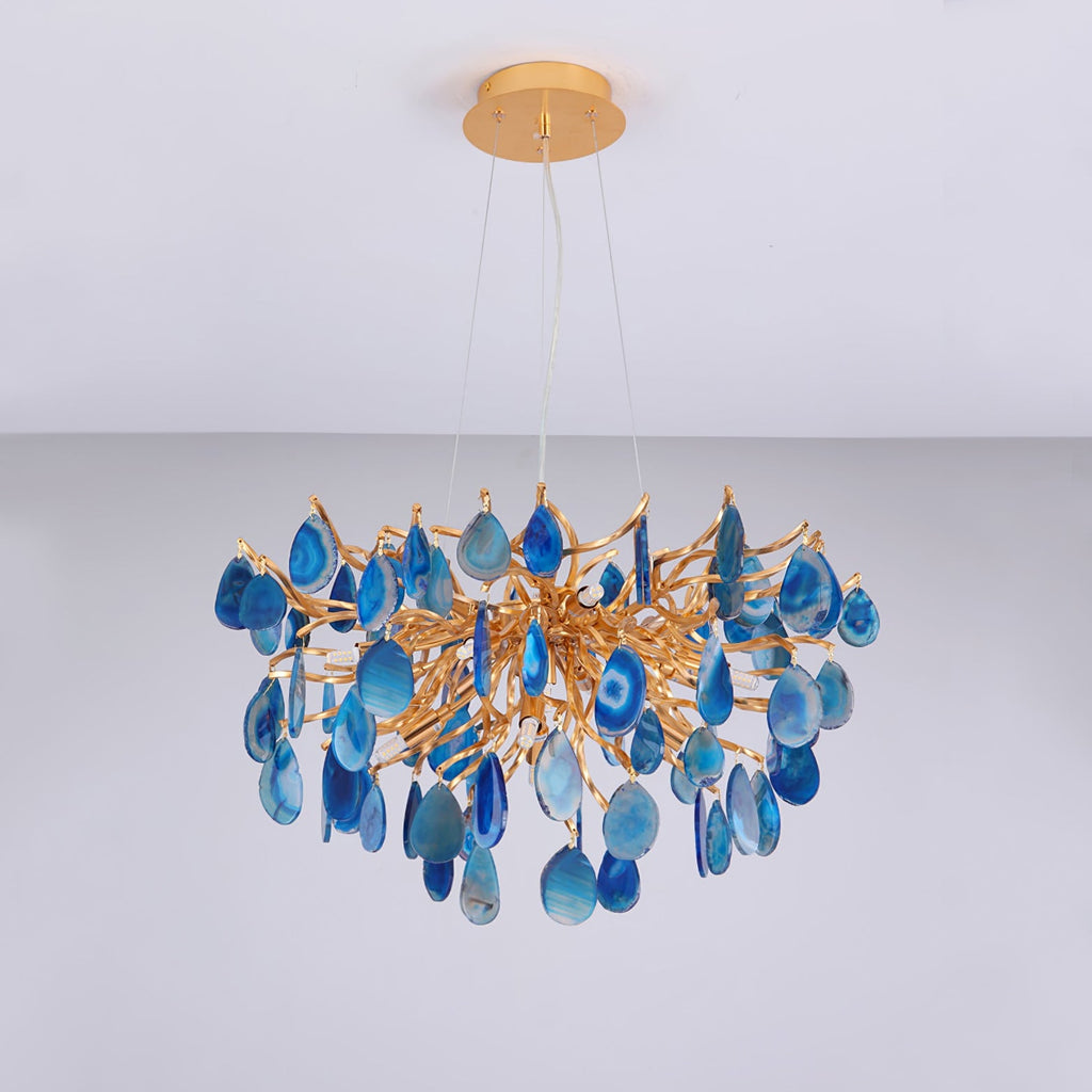 Unlit blue agate Clérachic chandelier hanging from a gold canopy, with the stone slices in shades from navy to pale sky blue.