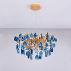 Unlit blue agate Clérachic chandelier hanging from a gold canopy, with the stone slices in shades from navy to pale sky blue.
