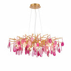 Pink agate Clérachic chandelier on a white backdrop, with rose and magenta slices hanging from a wide gold frame.