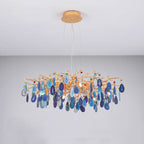 Wide blue agate Clérachic chandelier under a pale ceiling, with navy and turquoise slices on a gold branch frame.