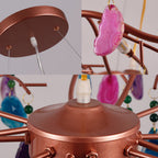 Three close views of this Clérachic agate chandelier: the ceiling plate, a pink agate slice by a bulb, and the central rose-gold hub.