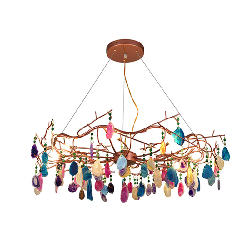 Multicolour Clérachic agate chandelier on a white backdrop, with pink, blue, gold and purple slices hanging from the rose-gold frame.
