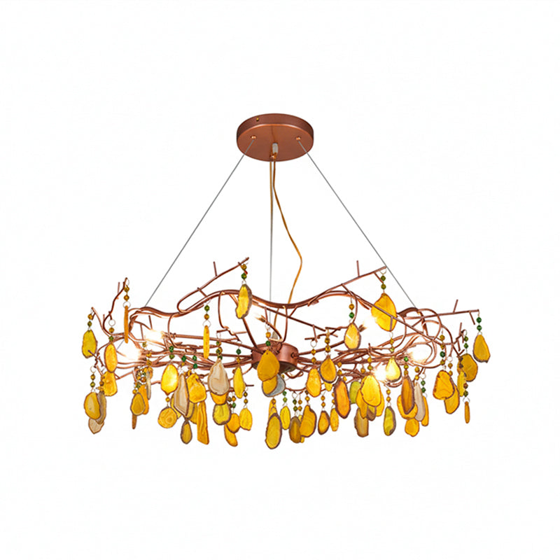 Yellow-slice Clérachic agate chandelier on a white backdrop, with its rose-gold branches and bulbs lit between the stones.
