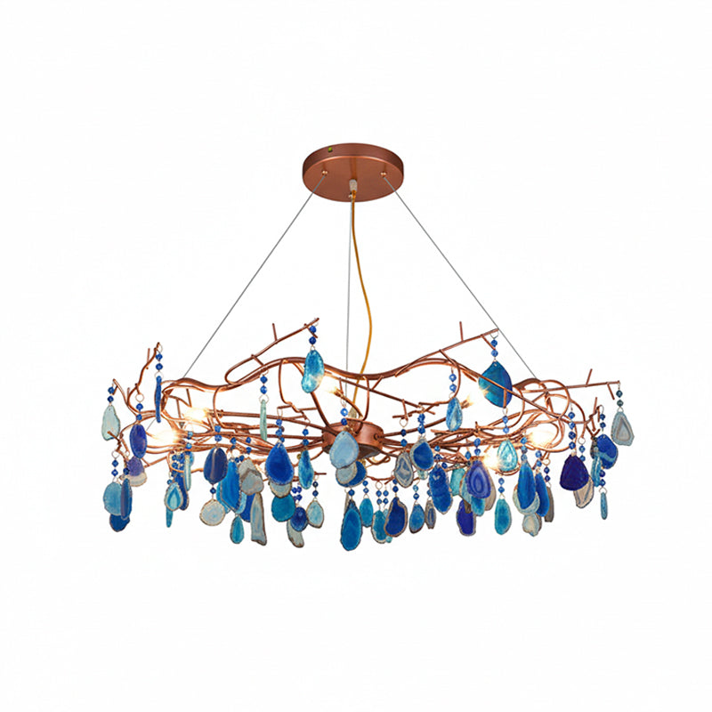 Blue-slice Clérachic agate chandelier on a white backdrop, with light and deep blue stones hanging from rose-gold branches.