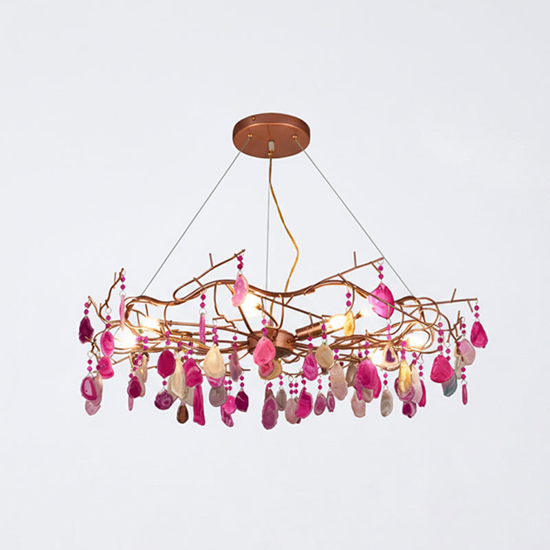 Pink-slice Clérachic agate chandelier on a pale grey backdrop, with magenta and blush stones hanging from the frame.