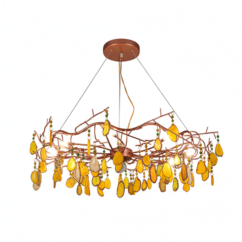Yellow-slice Clérachic agate chandelier on a white backdrop, with amber stones and green beads on the rose-gold frame.