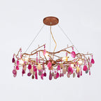 Pink-slice Clérachic agate chandelier on a pale grey backdrop, with hot pink and cream slices hung from its branch frame.