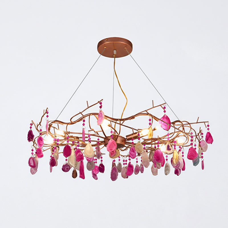 Pink-slice Clérachic agate chandelier on a pale grey backdrop, with hot pink and cream slices hung from its branch frame.