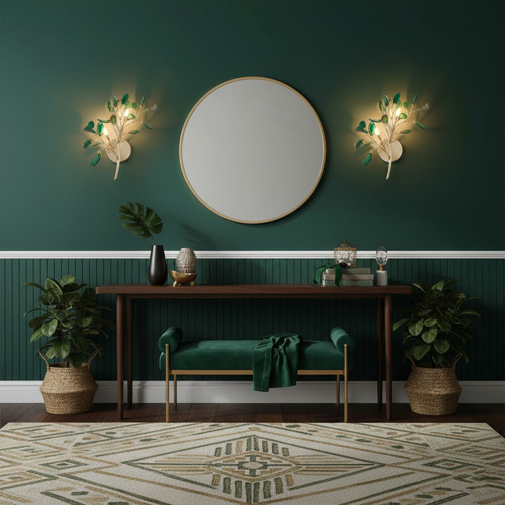 A pair of green-toned Clérachic agate wall lights on a deep green wall, either side of a round mirror above a console.