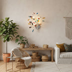 Multicolour Clérachic agate wall light on a cream wall in a living space with rattan furniture and a macramé hanging.