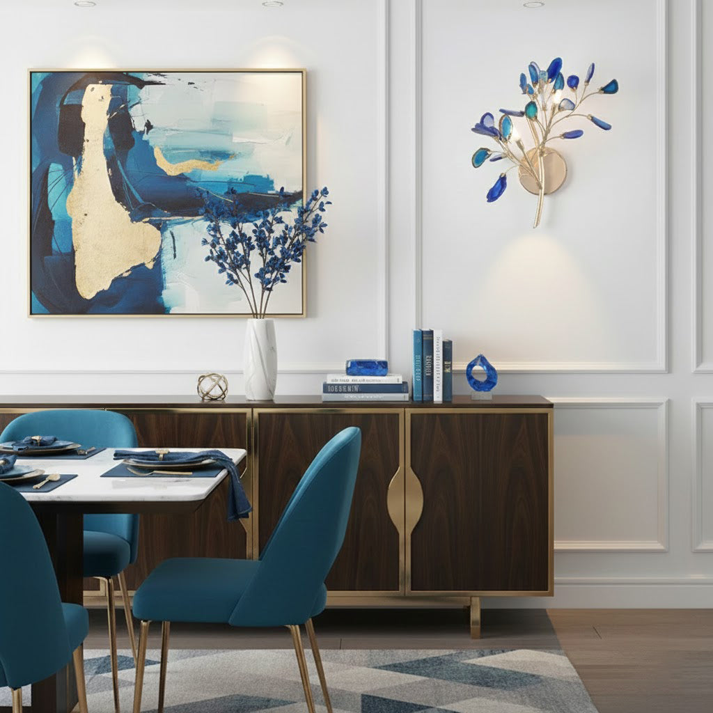 Blue Clérachic agate wall light on a white panelled wall beside an abstract painting, above a dark wood sideboard.