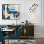 Blue Clérachic agate wall light on a white panelled wall beside an abstract painting, above a dark wood sideboard.