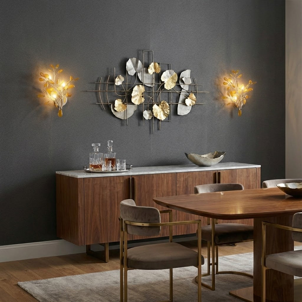 Two Clérachic agate wall lights glowing warm gold on a charcoal wall, either side of a metal wall sculpture above a sideboard.