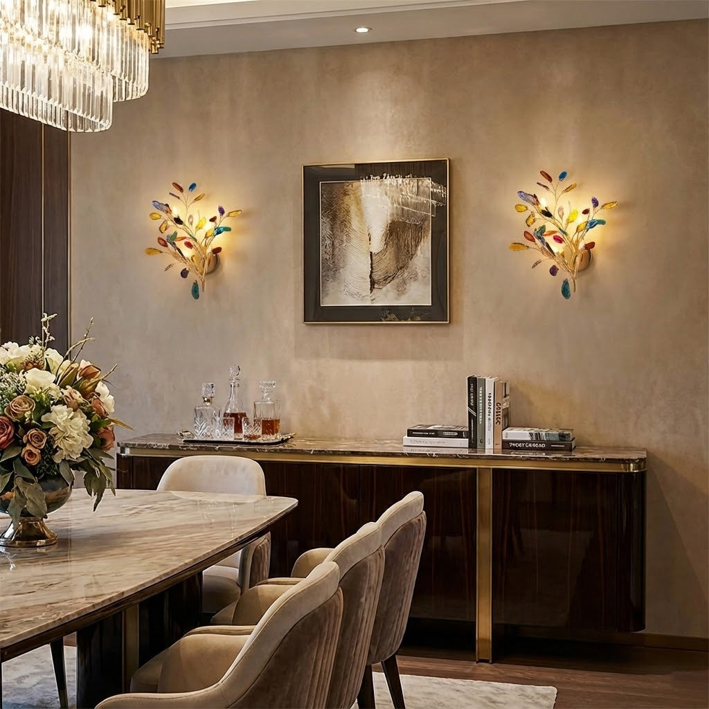 A pair of multicolour Clérachic agate wall lights lit on a warm taupe wall, either side of a framed artwork over a long console.