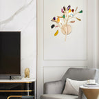 Multicolour Clérachic agate wall light on a panelled wall beside a television, with a grey armchair and marble wall below.