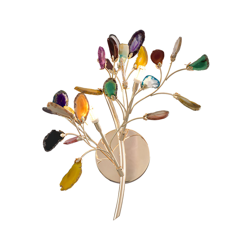 Close view of the gold stem and round back plate of this Clérachic agate wall light, with multicolour stone slices at the tips.