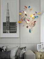 This Clérachic agate wall light on a grey wall beside a framed architectural print, above a sofa with patterned cushions.