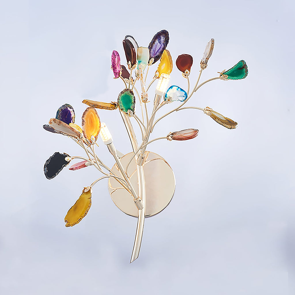 Side view of this Clérachic agate wall light with its candle-style bulbs, on a pale blue studio backdrop.