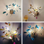 Four small photos of the Clérachic agate wall light lit in different colours, from teal and blue to multicolour.