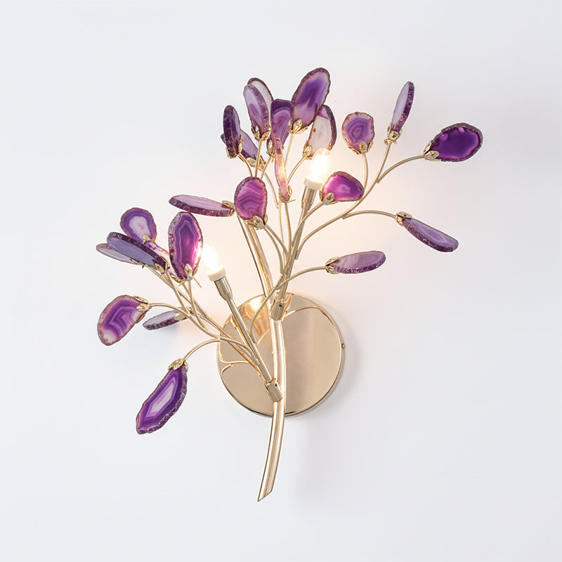 Purple Clérachic agate wall light on a pale wall, with violet and lilac stone slices around candle-style bulbs.