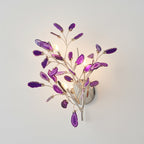 Larger purple Clérachic agate wall light lit on a pale wall, with violet slices around candle-style bulbs.