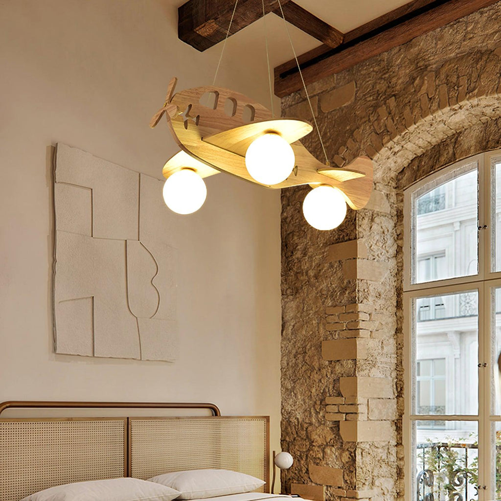 Clérachic airplane light glowing in a room with a stone arch, a tall window and a rattan bedhead below.