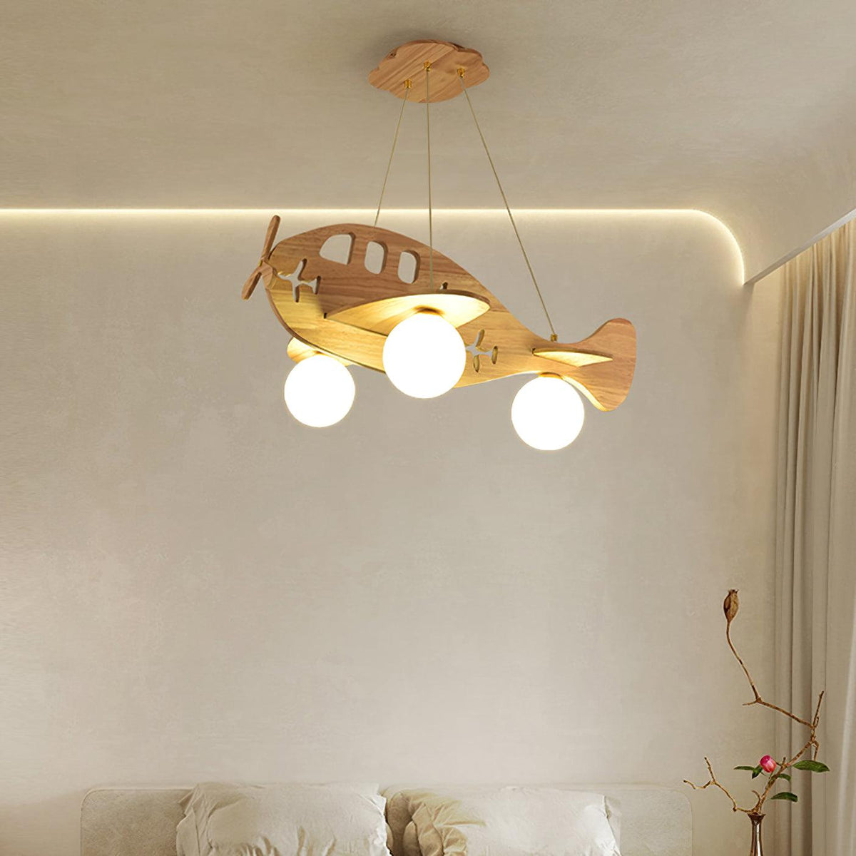 This Clérachic wooden airplane light glows in a warm cream room, with a soft cove light along the ceiling and a curtain beside it.