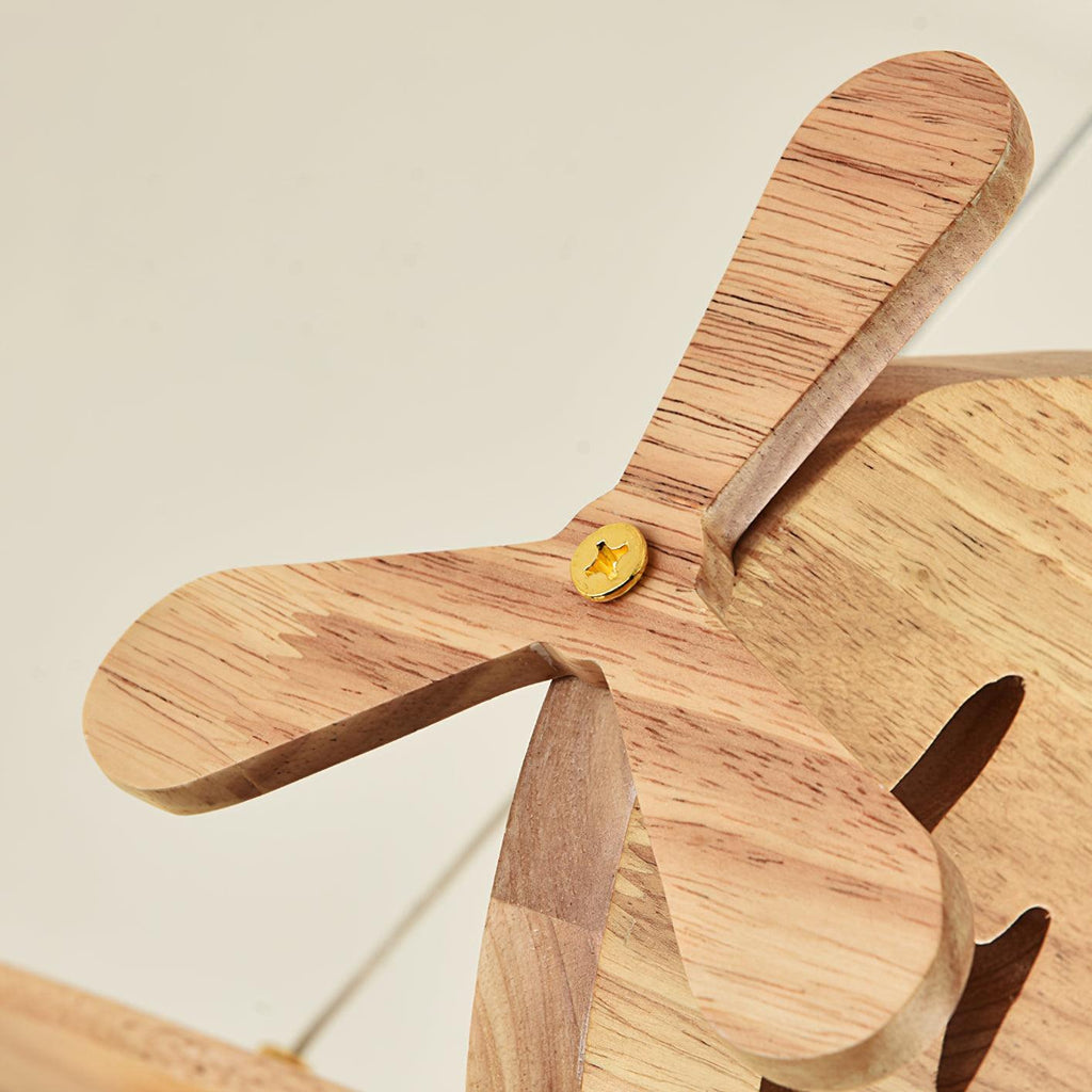 Close view of the wooden propeller and fuselage on this Clérachic airplane light, with a small brass pin at the centre.