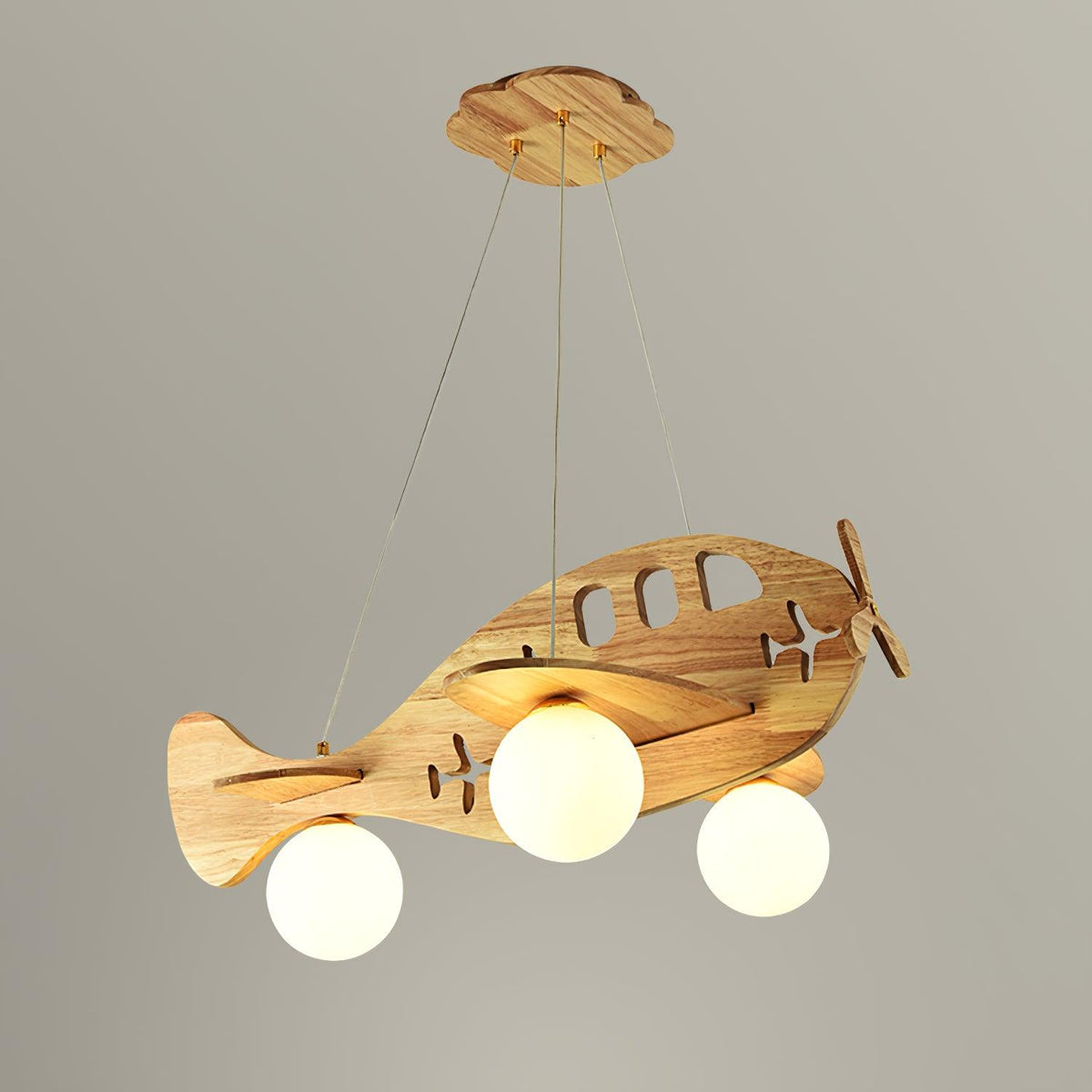 Clérachic airplane ceiling light with its cloud-shaped wooden canopy and three suspension wires, lit against a light grey backdrop.