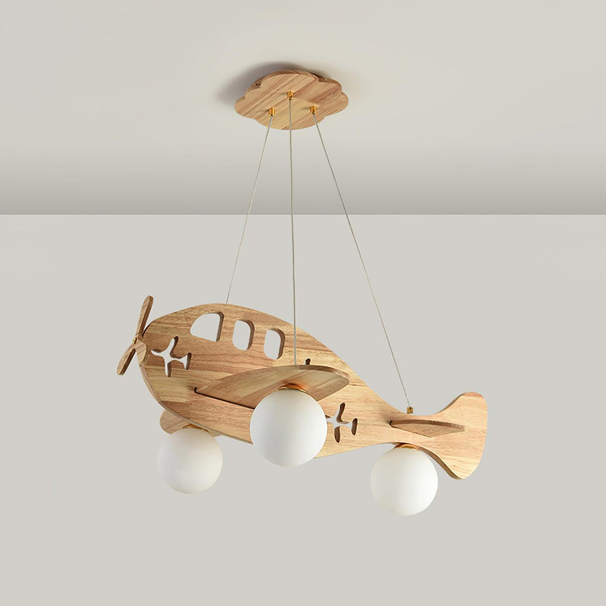 Clérachic wooden airplane pendant switched off against a soft grey wall, its three globes showing plain opal white.