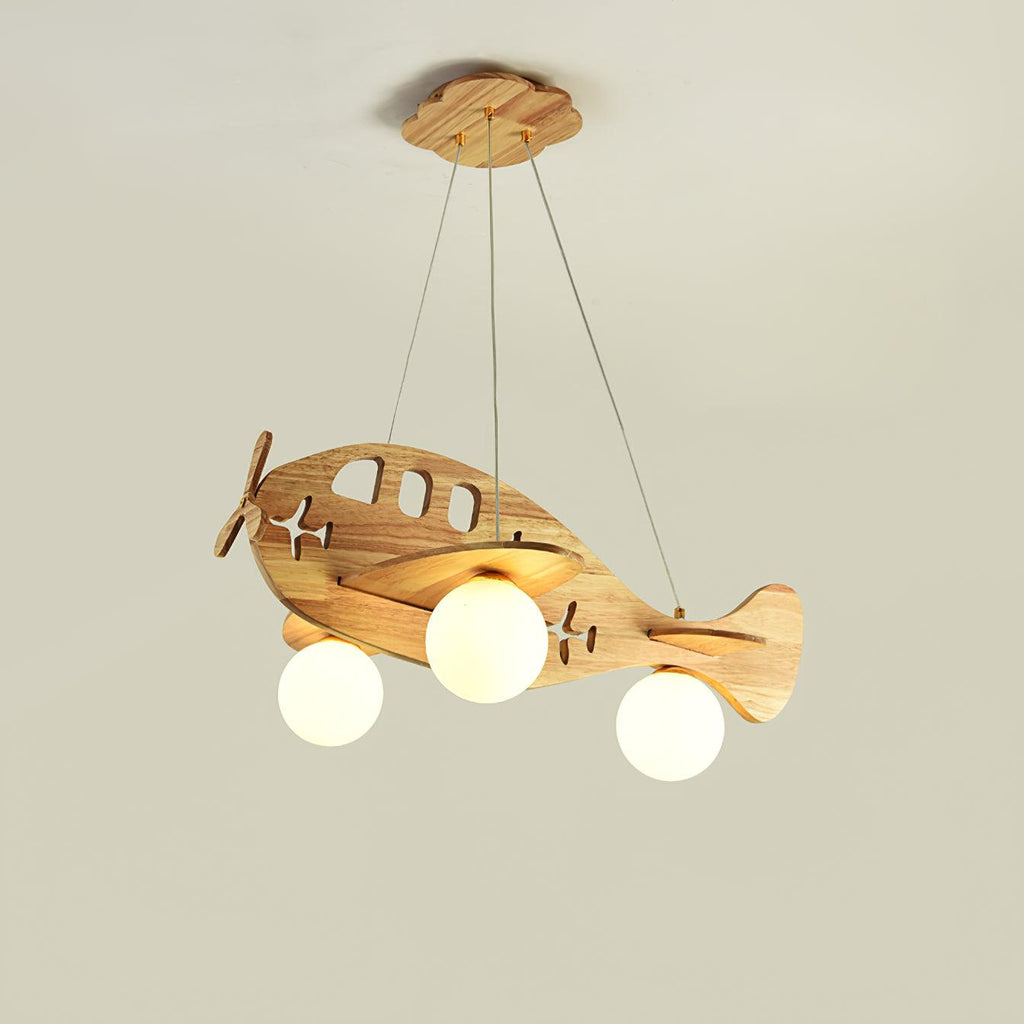 A Clérachic wooden airplane light lit against a pale beige wall, hung by its three wires from a wooden canopy.