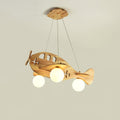 A Clérachic wooden airplane light lit against a pale beige wall, hung by its three wires from a wooden canopy.