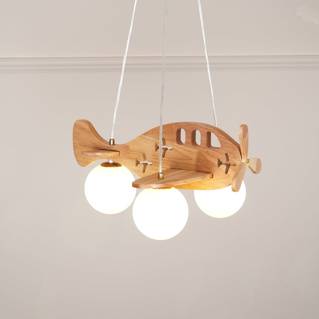 Low-angle view of the Clérachic airplane light under a plain ceiling with a ribbed cornice, its three globes lit and its wood grain visible.
