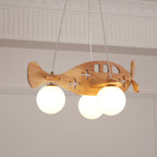 Close view from below of the Clérachic airplane light, the lit globes hanging beneath its wooden wings and cut-out windows.