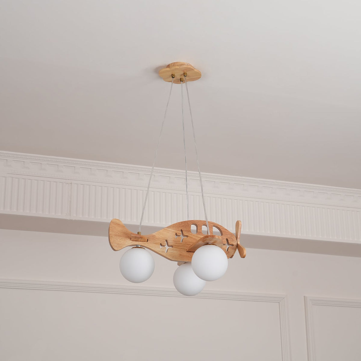 Clérachic airplane pendant hung below a ceiling cornice, with a plain white globe under each wing, seen from further back.