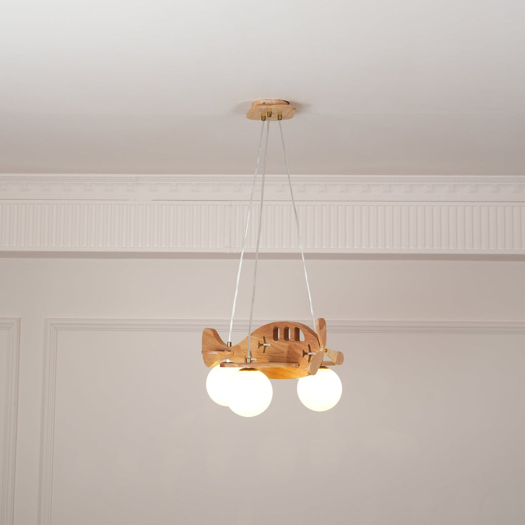 Clérachic airplane pendant lit in a panelled room, with a warm glow from all three globes beneath the wooden wings.