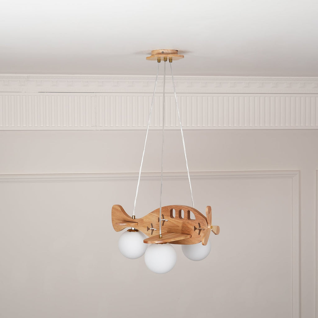 Clérachic wooden airplane light in a panelled room, its globes dim and its wings and propeller in natural wood.